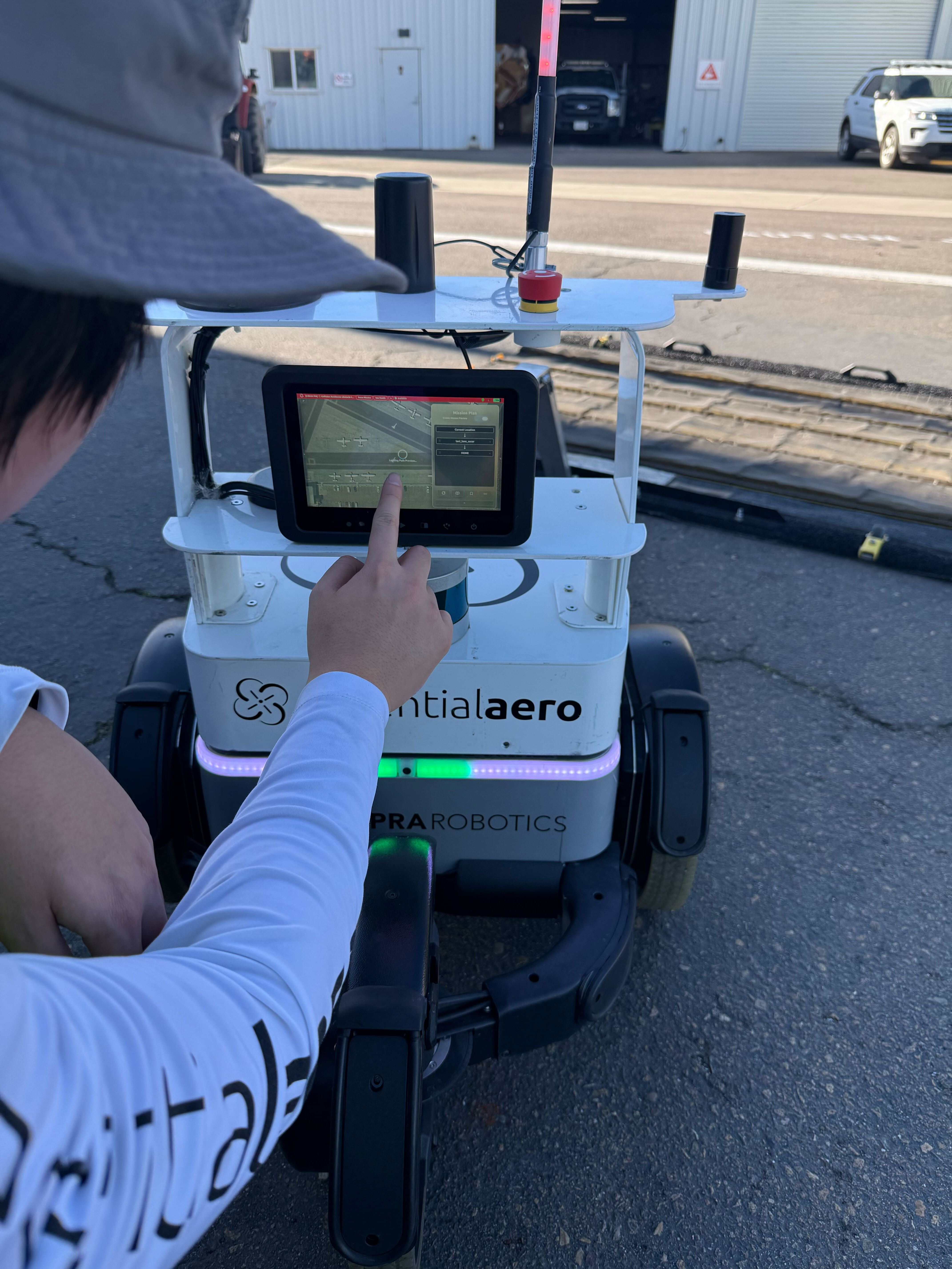Operator using the EA Console touchscreen interface on the robot before starting a mission